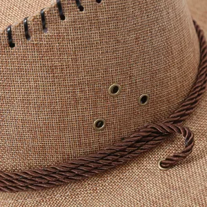 Close up texture detail of brown cotton linen cowboy sun hat with metal eyelets and rope.