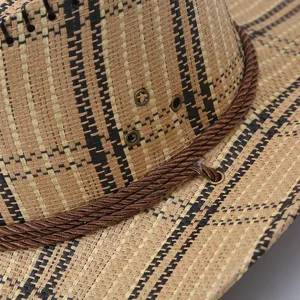 Close-up detail of summer straw cowboy hat with woven texture and brown twisted rope.