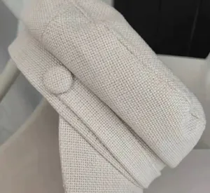 Close-up detail of casual linen cotton baker boy hat, textured weave fabric close shot.