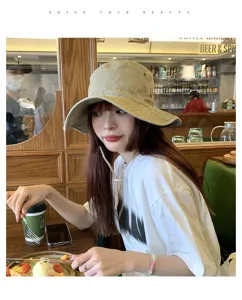 Washed cotton bucket hat for outdoor camping, vintage sun protection cap with windproof cord.