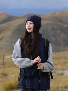 Detail view of the women winter knit beanie hat with ear protection and mountain embroidery.