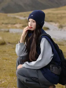 Winter outdoor knit beanie hat for women, dark blue thermal skiing cap with embroidered peak logo.