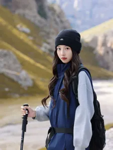 Detail view of the stylish black knit beanie with mountain embroidery for outdoor hiking.