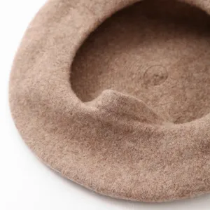 Close-up detail of a solid color wool beret, stylish vintage woolen painter hat for women.