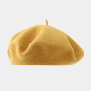 Detail view of the autumn winter solid color wool beret hat in yellow, minimalist retro style.