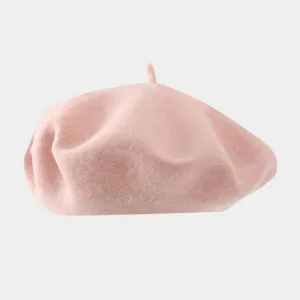 Close-up detail of a soft pink woolen beret, showing the fine texture and classic painter style.