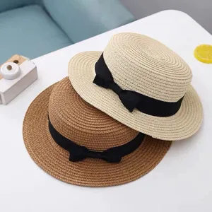 Classic British vintage flat top straw hat with elegant black bow, perfect sun protection beach hat.