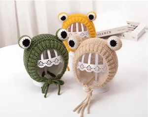 Cute infant frog fleece-lined knit hat for babies, warm winter knitwear with braided ties.
