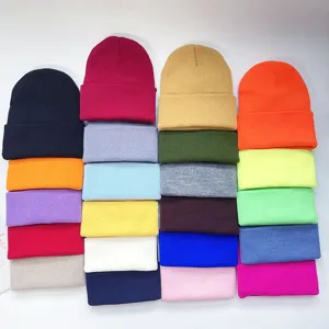 Assorted colorful knit beanie hats, winter warm solid color skull caps detail view.