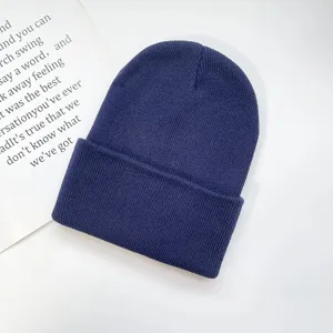 Classic solid dark blue winter knitted beanie hat for adults, warm and stylish cuff design.