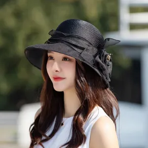 Black mesh sun hat for women, breathable summer bucket hat with elegant bow and floral decor.