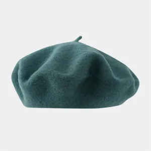 Detail view of the dark green wool beret, showcasing soft felt texture and classic shape.