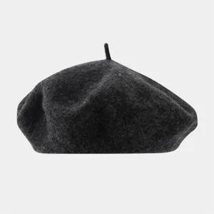Close-up of the dark grey wool beret showing soft texture and classic painter hat design.