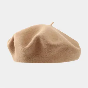 Detailed close-up of a cozy beige wool beret, soft felt texture, classic French style hat.