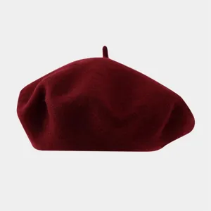 Detailed view of the solid burgundy wool beret, soft texture and classic vintage painter hat style.