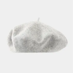 Close up view of a minimalist light grey wool beret, showcasing soft texture and fine knit detail.