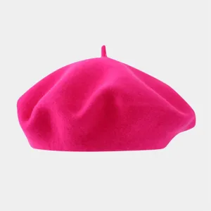 Detailed close-up of hot pink wool beret, showcasing soft texture and classic design.