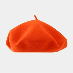 Detailed view of the orange wool beret showing soft textured fabric and classic shape.