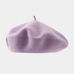 Close-up detail of the soft wool beret texture, showing fine craftsmanship and fabric quality.