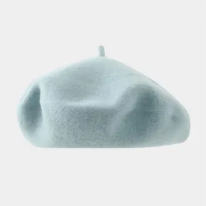 Light blue wool beret hat detail, minimalist solid color painter hat close-up view.