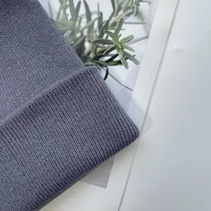 Close-up detail of soft knit winter beanie hat, premium ribbed texture craftsmanship.
