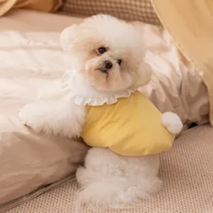 Cozy pet apparel detail featuring a yellow winter vest with cute white bunny tail and ruffles.