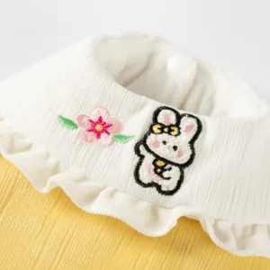 Cute rabbit embroidery pet clothes detail, warm winter dog apparel with delicate ruffles.
