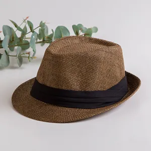 Brown straw fedora hat with black ribbon band, classic summer sun beach panama cap style.