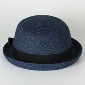 Navy straw bowler hat detail showcasing fine woven texture and elegant black side bow accessory.