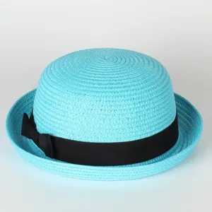 Close up view of the light blue straw bowler hat detail showing fine woven texture and black bow.