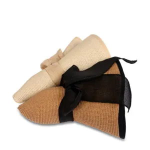 Details showing rolled straw sun hat with black bow, foldable beach hat for summer vacation.