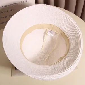 French elegant women summer beach sun hat detail view, white woven straw bucket hat inner structure.