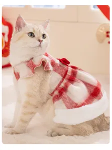 Detailed shot of Christmas plaid cat dress with fluffy trim and bow for winter pet wear.