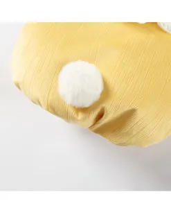 Nahaufnahme der gelben gerippten Haustierweste mit flauschigem weißem Plüsch-Pompon-Schwanz.