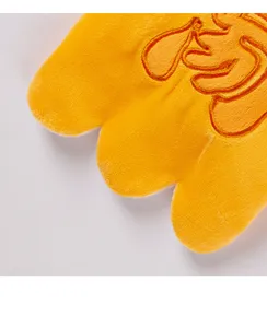 Detaillierte Nahaufnahme von weicher gelber Plüsch-Haustierbekleidung mit Stickerei.