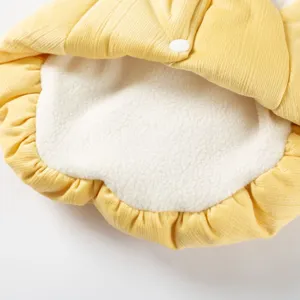 Detail shot of yellow corduroy pet winter warm coat with white plush lining and snap button.