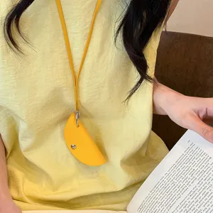 Minimalist leather dumpling pouch keychain, portable glasses clip accessory, stylish Korean design.