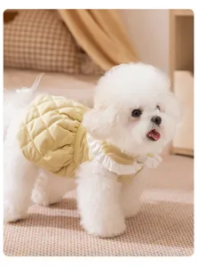 Close-up detail of warm winter pet princess dress with quilted fabric and white frilly collar.