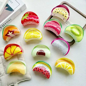 Detailed view of various fruit-printed hair claw clips including strawberry and avocado designs
