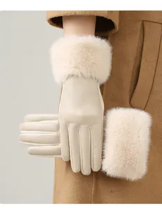 Close-up detail of women's thermal leather winter gloves with plush fur cuffs in beige