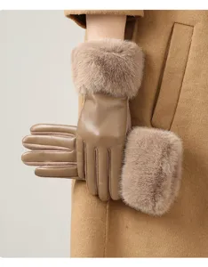 Detailed view of women's warm winter leather gloves featuring thick plush fur cuffs.