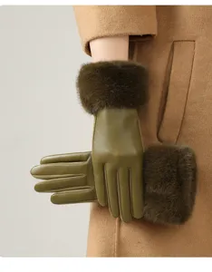 Detail of women's olive green leather gloves featuring plush faux fur cuffs for winter warmth.