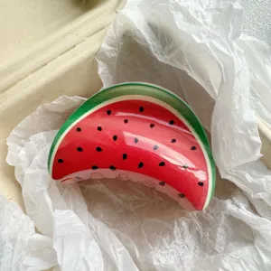Close-up of a fruit-print hair claw clip featuring a vibrant watermelon design