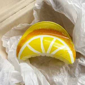 Close-up of a fruit printed lemon hair claw clip in white wrapping paper
