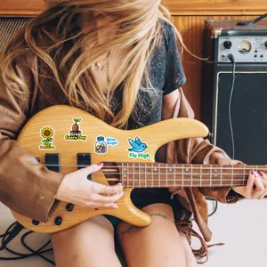 Close-up detail shot of colorful waterproof positive quote stickers decorated on a bass guitar.