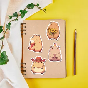 Close-up detail showing cute capybara sticker designs on a notebook for DIY decoration.
