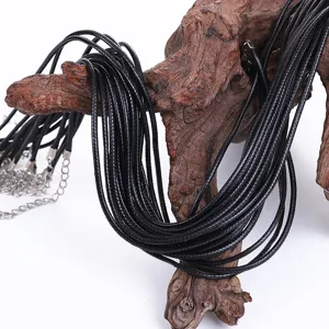 Close-up detail of bulk black DIY waxed cord necklaces with silver lobster clasps