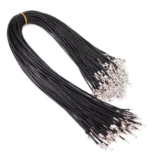 Close-up of bulk black waxed necklace cords with silver lobster clasps for DIY jewelry