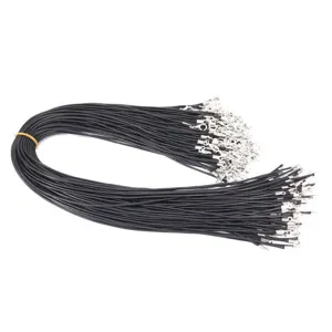 Macro detail of black waxed necklace cords with silver lobster clasps for DIY jewelry crafts