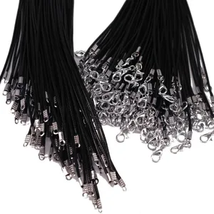 Macro detail of black waxed necklace cords featuring silver-tone lobster clasps for DIY